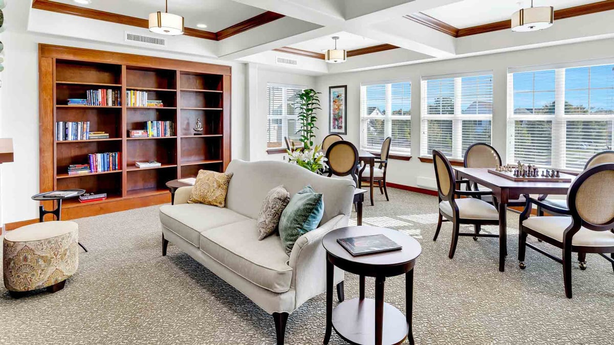 The library at Capitol Ridge with shelves of books and comfortable seating